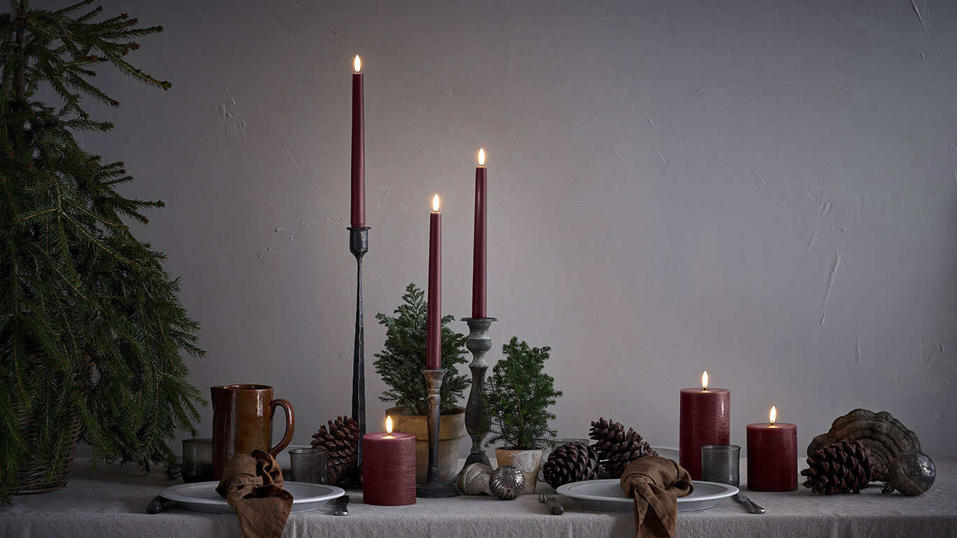 Carmine red collection of flameless candles in a Christmas scene