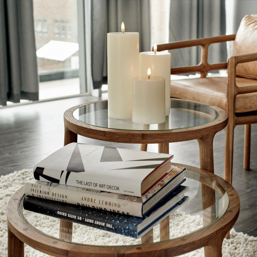 Trio of creamy ivory real wax flameless candles on EKTA Holmes Scandi coffee table