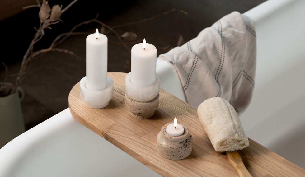 Scandinavian-inspired bathroom styling featuring Uyuni Lighting Classic Ivory Flameless Pillar Candles and Tea Light, creating a luxurious spa-like retreat with warm ambient lighting.